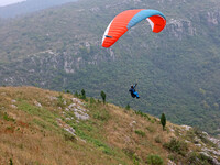 A paraglider flies in the air at a cloud-deep flight camp in Zaozhuang, China, on October 6, 2024. (