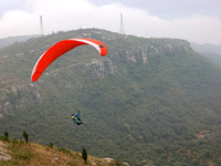 A paraglider flies in the air at a cloud-deep flight camp in Zaozhuang, China, on October 6, 2024. (