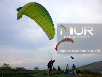 A paraglider flies in the air at a cloud-deep flight camp in Zaozhuang, China, on October 6, 2024. (