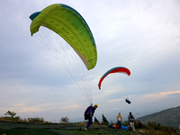 A paraglider flies in the air at a cloud-deep flight camp in Zaozhuang, China, on October 6, 2024. (