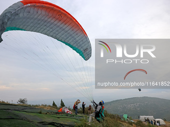 A paraglider flies in the air at a cloud-deep flight camp in Zaozhuang, China, on October 6, 2024. (