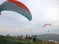 A paraglider flies in the air at a cloud-deep flight camp in Zaozhuang, China, on October 6, 2024. (