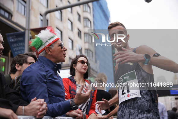 Francesco Fortunato talks with a fan during the international race 10km march in Madrid, Spain, on October 6. 