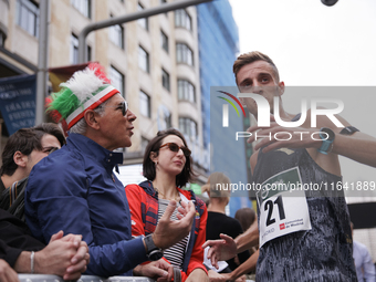 Francesco Fortunato talks with a fan during the international race 10km march in Madrid, Spain, on October 6. (