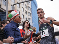 Francesco Fortunato talks with a fan during the international race 10km march in Madrid, Spain, on October 6. (