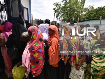 People wait in queue to check their names on the draft list at the National Register of Citizens (NRC) center in a village in Nagaon distric...