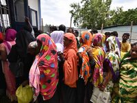 People wait in queue to check their names on the draft list at the National Register of Citizens (NRC) center in a village in Nagaon distric...