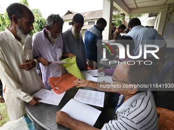 People check their names on the draft list at the National Register of Citizens (NRC) center in a village in Nagaon district, Assam, India,...