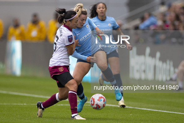 Lauren Hemp #11 of Manchester City W.F.C. is tackled by an opponent during the Barclays FA Women's Super League match between Manchester Cit...