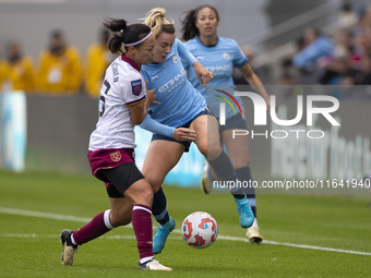 Lauren Hemp #11 of Manchester City W.F.C. is tackled by an opponent during the Barclays FA Women's Super League match between Manchester Cit...