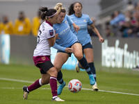 Lauren Hemp #11 of Manchester City W.F.C. is tackled by an opponent during the Barclays FA Women's Super League match between Manchester Cit...