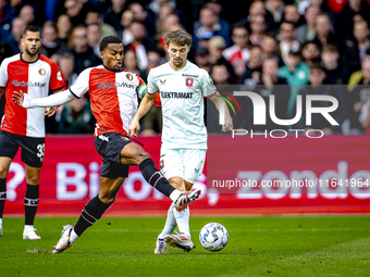 Feyenoord Rotterdam midfielder Quinten Timber and FC Twente midfielder Youri Regeer play during the match between Feyenoord and Twente at th...