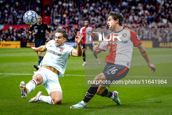 FC Twente defender Bart van Rooij and Feyenoord Rotterdam defender Hugo Bueno play during the match between Feyenoord and Twente at the Feye...