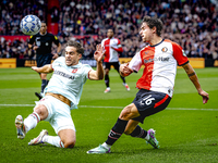 FC Twente defender Bart van Rooij and Feyenoord Rotterdam defender Hugo Bueno play during the match between Feyenoord and Twente at the Feye...