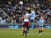 Lauren Hemp #11 of Manchester City W.F.C. engages in an aerial challenge with Li Mengwen #26 of West Ham United F.C. during the Barclays FA...