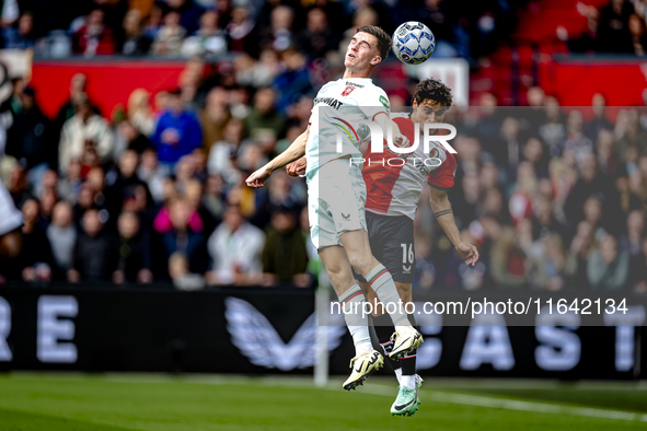 FC Twente forward Daan Rots and Feyenoord Rotterdam defender Hugo Bueno play during the match between Feyenoord and Twente at the Feyenoord...