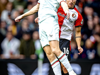 FC Twente forward Daan Rots and Feyenoord Rotterdam defender Hugo Bueno play during the match between Feyenoord and Twente at the Feyenoord...