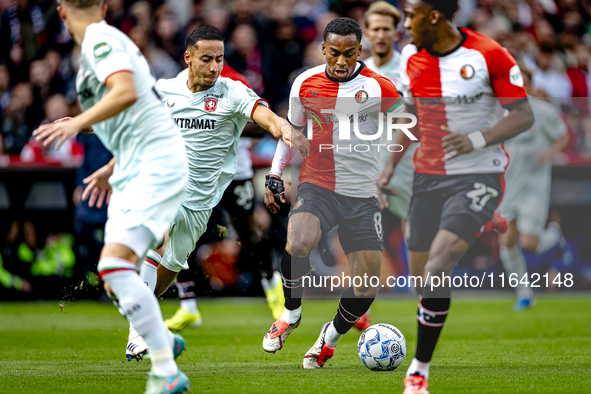 FC Twente defender Anass Salah-Eddine and Feyenoord Rotterdam midfielder Quinten Timber play during the match between Feyenoord and Twente a...