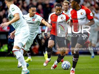 FC Twente defender Anass Salah-Eddine and Feyenoord Rotterdam midfielder Quinten Timber play during the match between Feyenoord and Twente a...