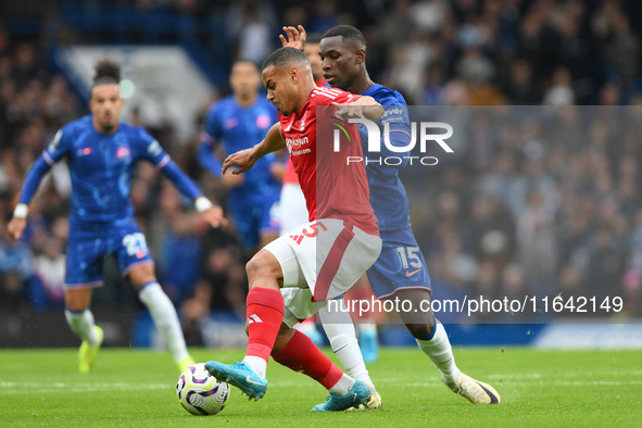 Murillo of Nottingham Forest tackles Nicolas Jackson of Chelsea during the Premier League match between Chelsea and Nottingham Forest at Sta...