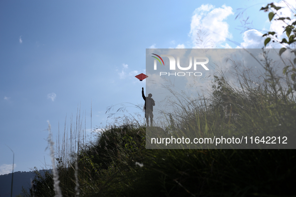 Nepalese people fly kites in the open space in Kathmandu, Nepal, on October 5, 2024. 