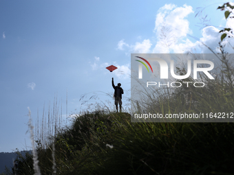 Nepalese people fly kites in the open space in Kathmandu, Nepal, on October 5, 2024. (