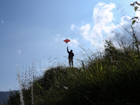 Nepalese people fly kites in the open space in Kathmandu, Nepal, on October 5, 2024. (