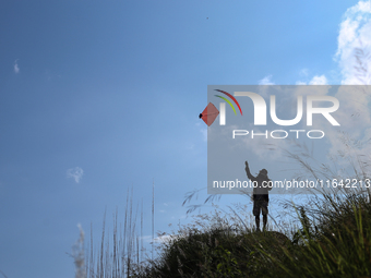 Nepalese people fly kites in the open space in Kathmandu, Nepal, on October 5, 2024. (