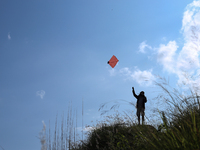 Nepalese people fly kites in the open space in Kathmandu, Nepal, on October 5, 2024. (