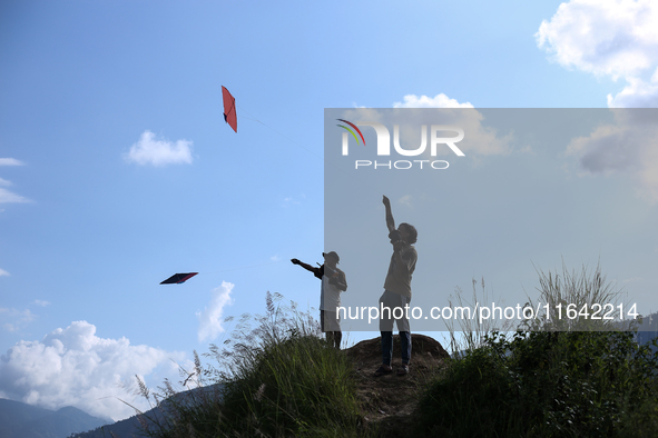 Nepalese people fly kites in the open space in Kathmandu, Nepal, on October 5, 2024. 