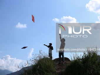 Nepalese people fly kites in the open space in Kathmandu, Nepal, on October 5, 2024. (