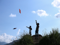 Nepalese people fly kites in the open space in Kathmandu, Nepal, on October 5, 2024. (