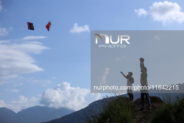 Nepalese people fly kites in the open space in Kathmandu, Nepal, on October 5, 2024. 