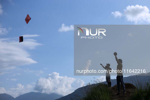 Nepalese people fly kites in the open space in Kathmandu, Nepal, on October 5, 2024. 