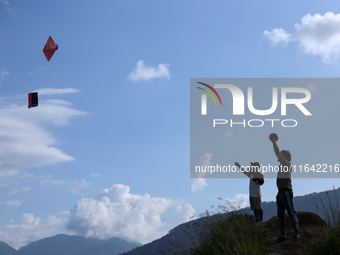 Nepalese people fly kites in the open space in Kathmandu, Nepal, on October 5, 2024. (