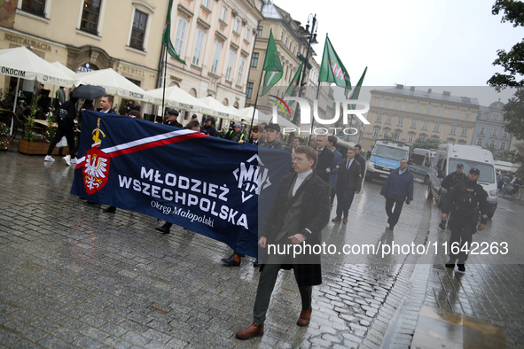 Participants of the All-Polish Youth March, a far-right ultranationalist organization, pass through the Main Square in Krakow, Poland, on Oc...