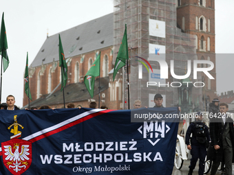 Participants of the All-Polish Youth March, a far-right ultranationalist organization, pass through the Main Square in Krakow, Poland, on Oc...