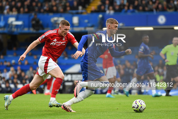 Cole Palmer of Chelsea is under pressure from Elliott Anderson of Nottingham Forest during the Premier League match between Chelsea and Nott...