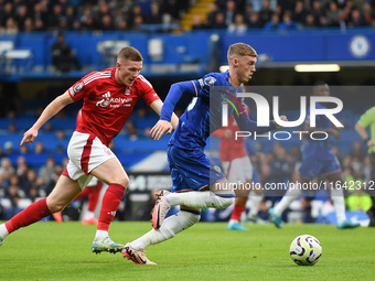 Cole Palmer of Chelsea is under pressure from Elliott Anderson of Nottingham Forest during the Premier League match between Chelsea and Nott...