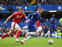 Cole Palmer of Chelsea is under pressure from Elliott Anderson of Nottingham Forest during the Premier League match between Chelsea and Nott...