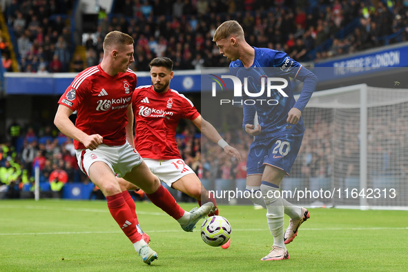 Cole Palmer of Chelsea is under pressure from Elliott Anderson and Alex Moreno of Nottingham Forest during the Premier League match between...