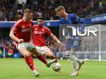 Cole Palmer of Chelsea is under pressure from Elliott Anderson and Alex Moreno of Nottingham Forest during the Premier League match between...