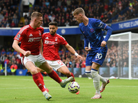 Cole Palmer of Chelsea is under pressure from Elliott Anderson and Alex Moreno of Nottingham Forest during the Premier League match between...