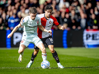 FC Twente forward Daan Rots and Feyenoord Rotterdam defender Hugo Bueno play during the match between Feyenoord and Twente at the Feyenoord...