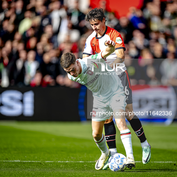 FC Twente forward Daan Rots and Feyenoord Rotterdam defender Hugo Bueno play during the match between Feyenoord and Twente at the Feyenoord...