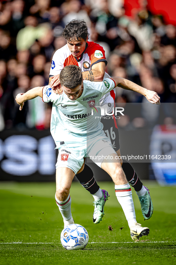 FC Twente forward Daan Rots and Feyenoord Rotterdam defender Hugo Bueno play during the match between Feyenoord and Twente at the Feyenoord...