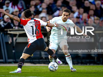 FC Twente defender Bart van Rooij and Feyenoord Rotterdam defender Hugo Bueno play during the match between Feyenoord and Twente at the Feye...