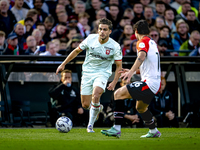 FC Twente defender Bart van Rooij and Feyenoord Rotterdam defender Hugo Bueno play during the match between Feyenoord and Twente at the Feye...