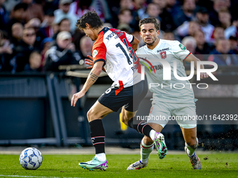 FC Twente defender Bart van Rooij and Feyenoord Rotterdam defender Hugo Bueno play during the match between Feyenoord and Twente at the Feye...