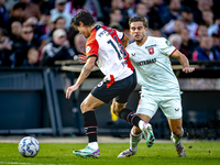 FC Twente defender Bart van Rooij and Feyenoord Rotterdam defender Hugo Bueno play during the match between Feyenoord and Twente at the Feye...